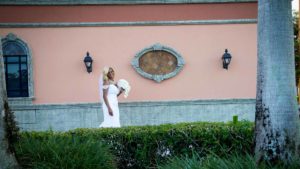 Bride posing in between some tress, in front of the Signature Grand