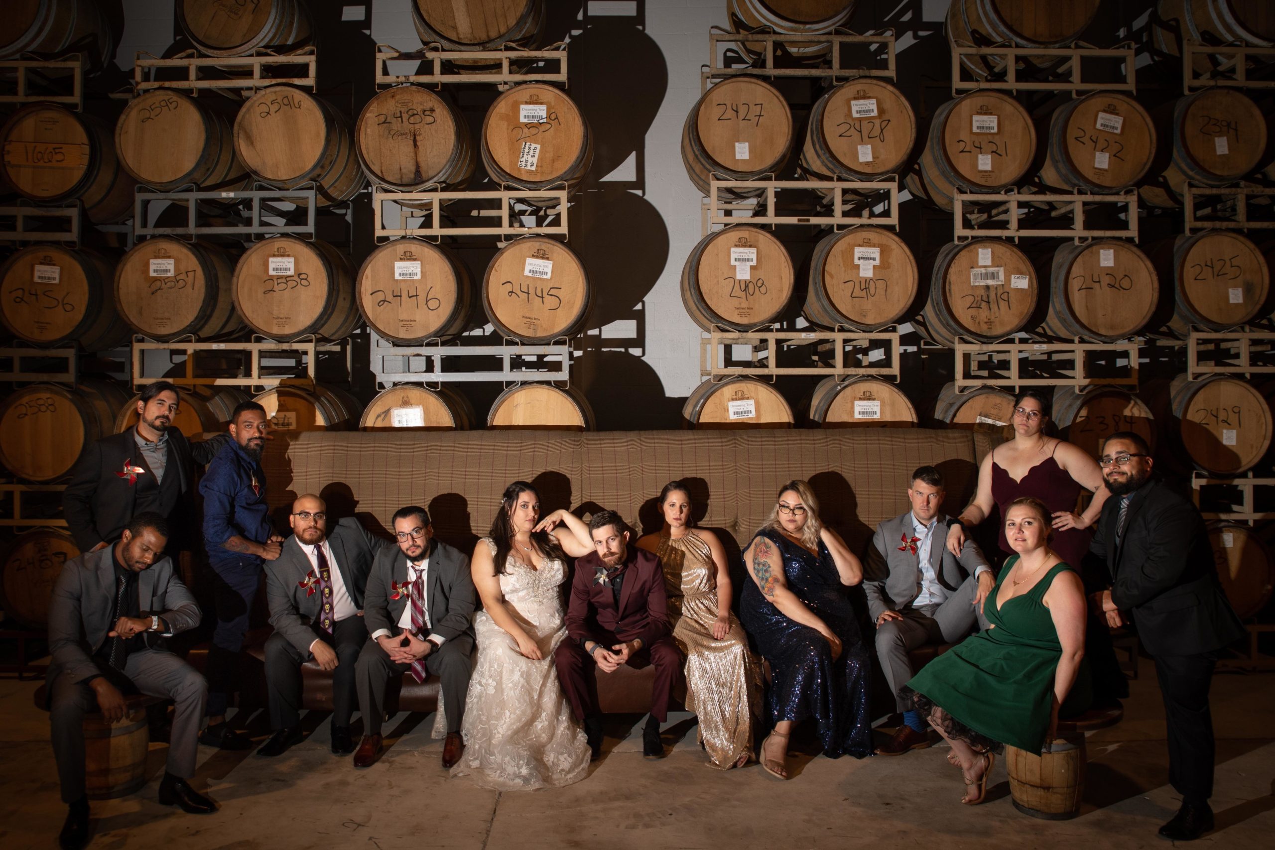 wedding party sitting in front of barrels of beer at Funky Buddha Brewery