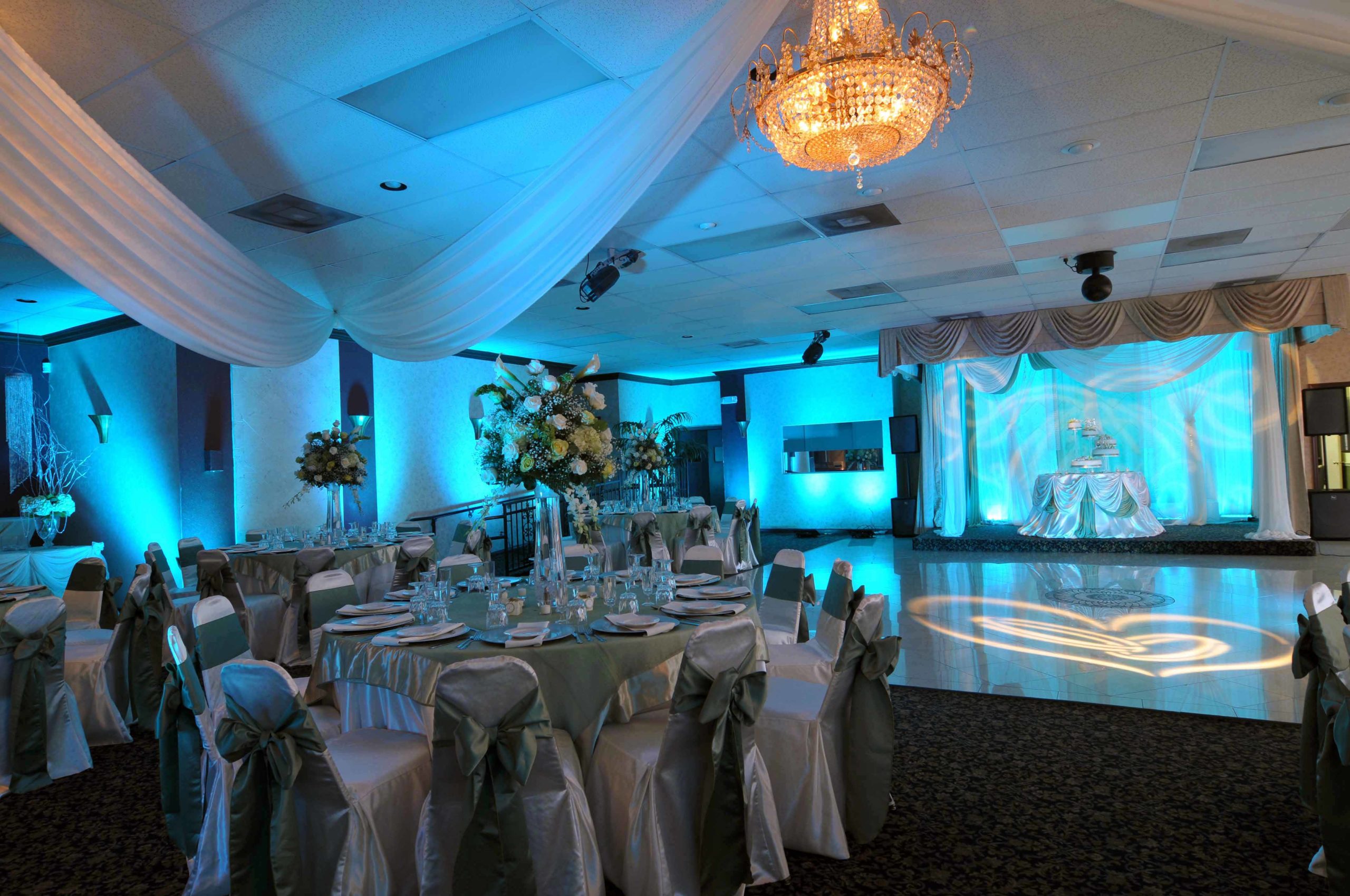 Wedding reception ballroom with blue up lighting