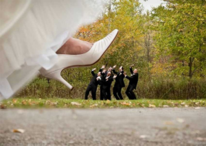bride stepping on wedding party