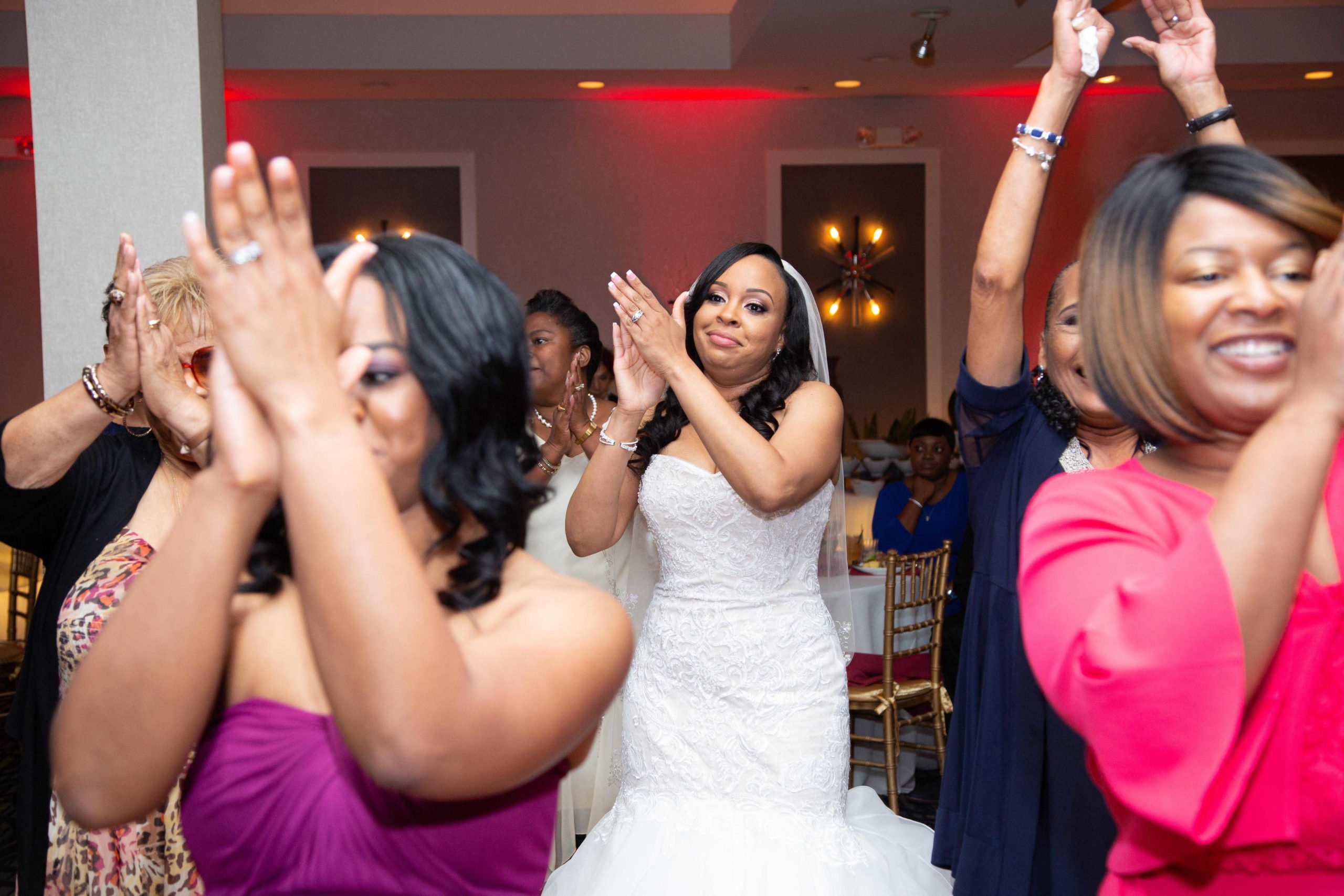 Bride doing the cha cha slide at Jacaranda Country Club wedding reception