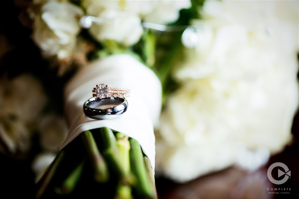 wedding rings on top of bridal bouquet