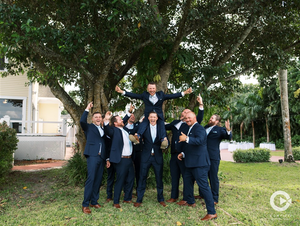 groomsmen in navy blue suits