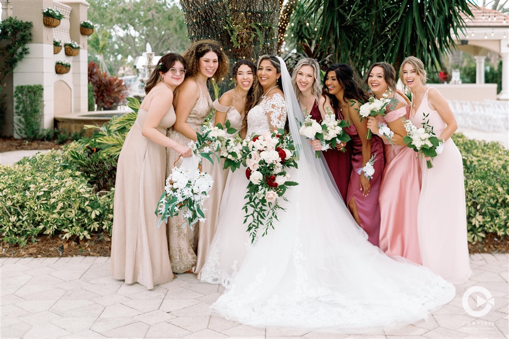 Bridesmaids and bride outdoor wedding photos at The Club at the Strand in Naples, FL.