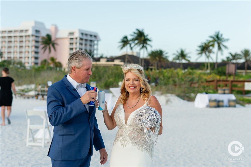 Bride and groom toast at Hilton Marco Island beach.
