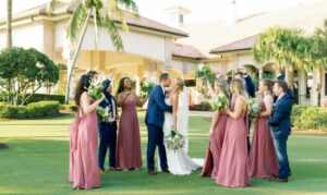 Groom Kisses Bride with Bridal Party on Lawn at Grandezza wedding in Fort Myers