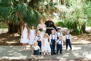 Newlywed Bride and Groom pose with the children in the wedding party