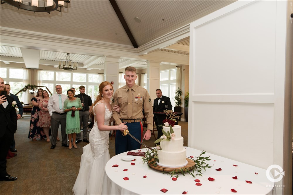 Newlywed bride and groom cut wedding cake at The Verandah Club in Fort Myers