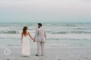 Newlyweds hand-in-hand on Beach