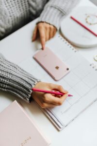 person filling out a date planner - a perfect way to have a stress-free destination wedding