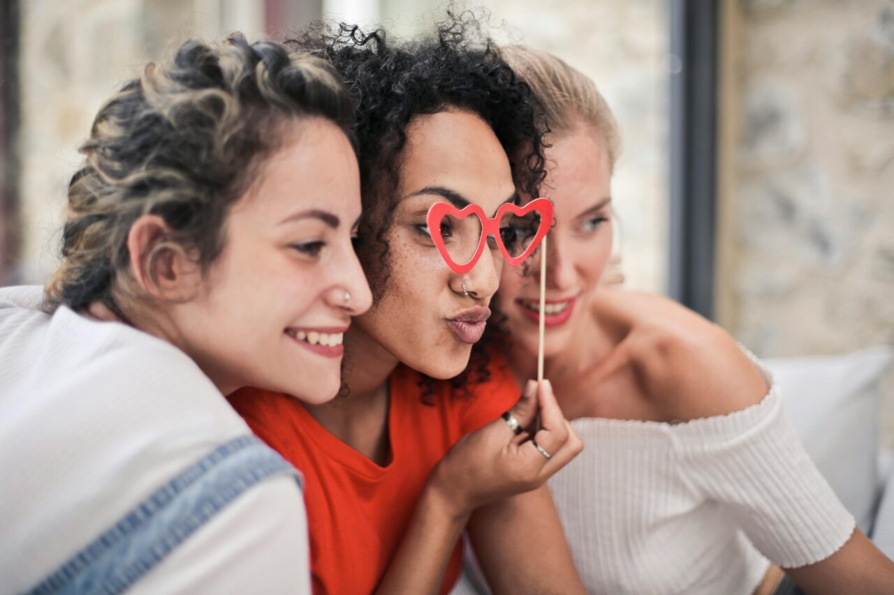 Guests pose in a photo booth. But Digital Photo Booth vs. Print. Which is best?