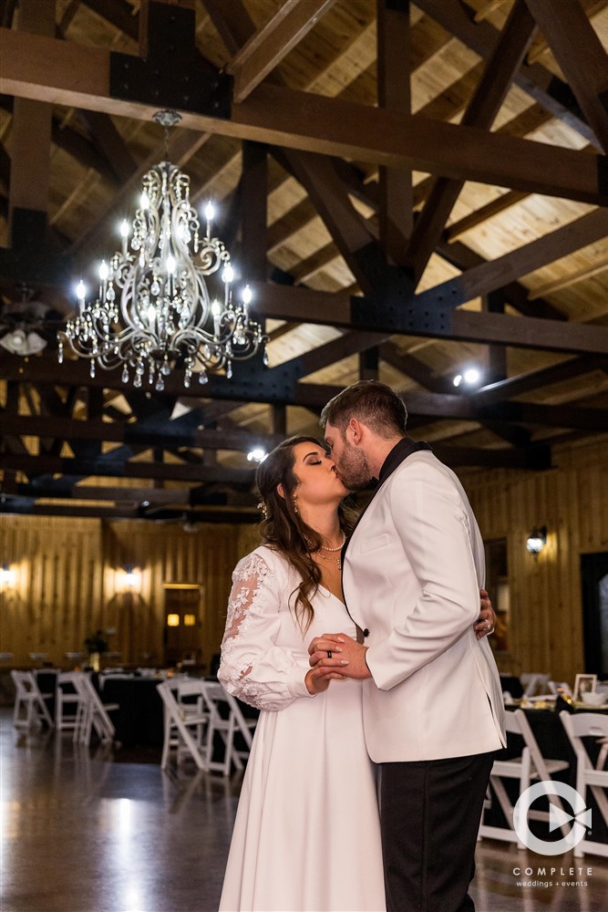 bride and groom with chandelier