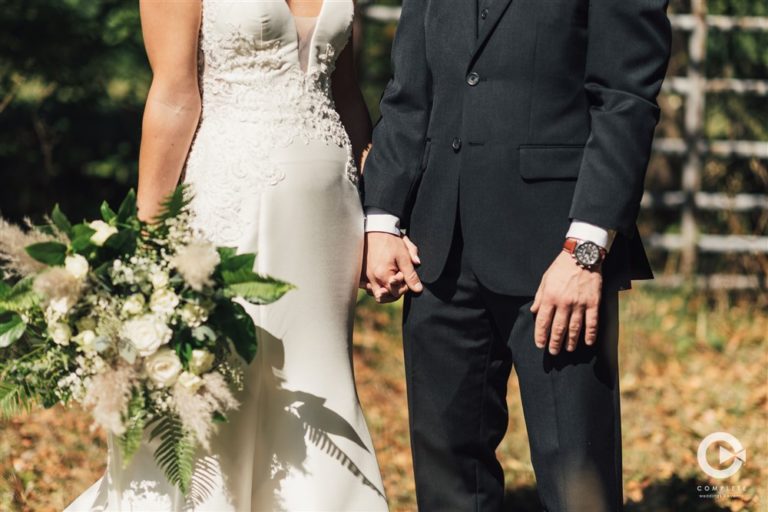 bride and groom hold hands