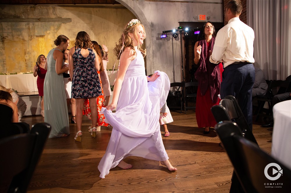 WEDDING MUSIC MISTAKES TO AVOID FLOWERGIRL ENJOYS A TWIRL ON THE DANCE FLOOR INDIANAPOLIS WEDDING