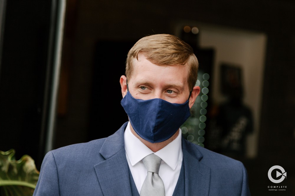 groom wears mask at wedding