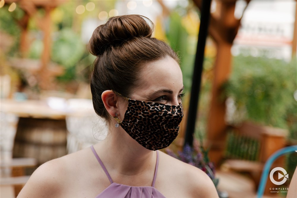 bridesmaid wears mask at wedding