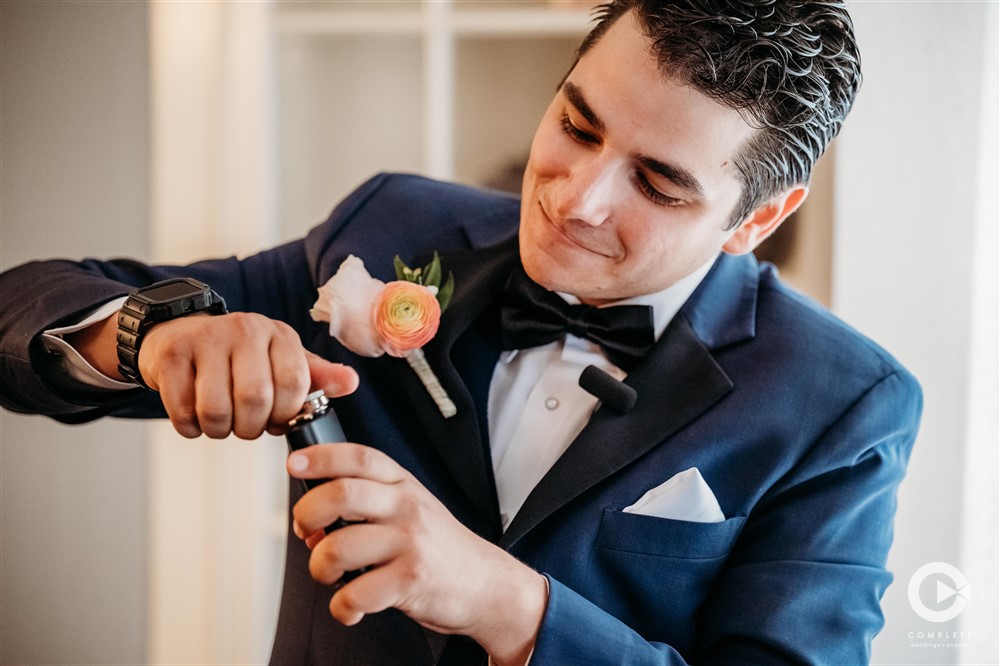 groom holding flask