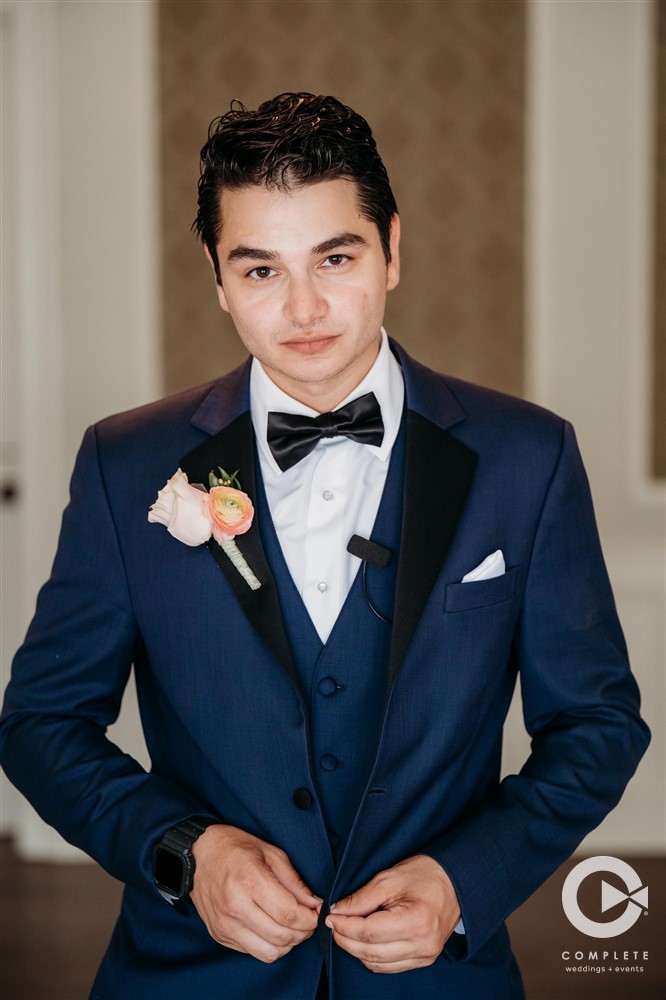 groom in navy blue tux