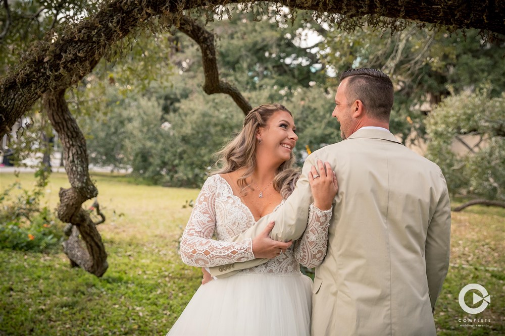 Ashley + Cory's Jacksonville Wedding at Treaty Park Bride holding groom at Treaty Park January wedding reception