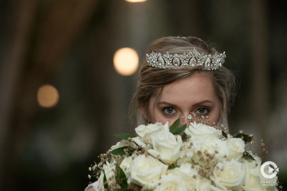 Bride looking at camera over her amazing Jacksonville bouquet