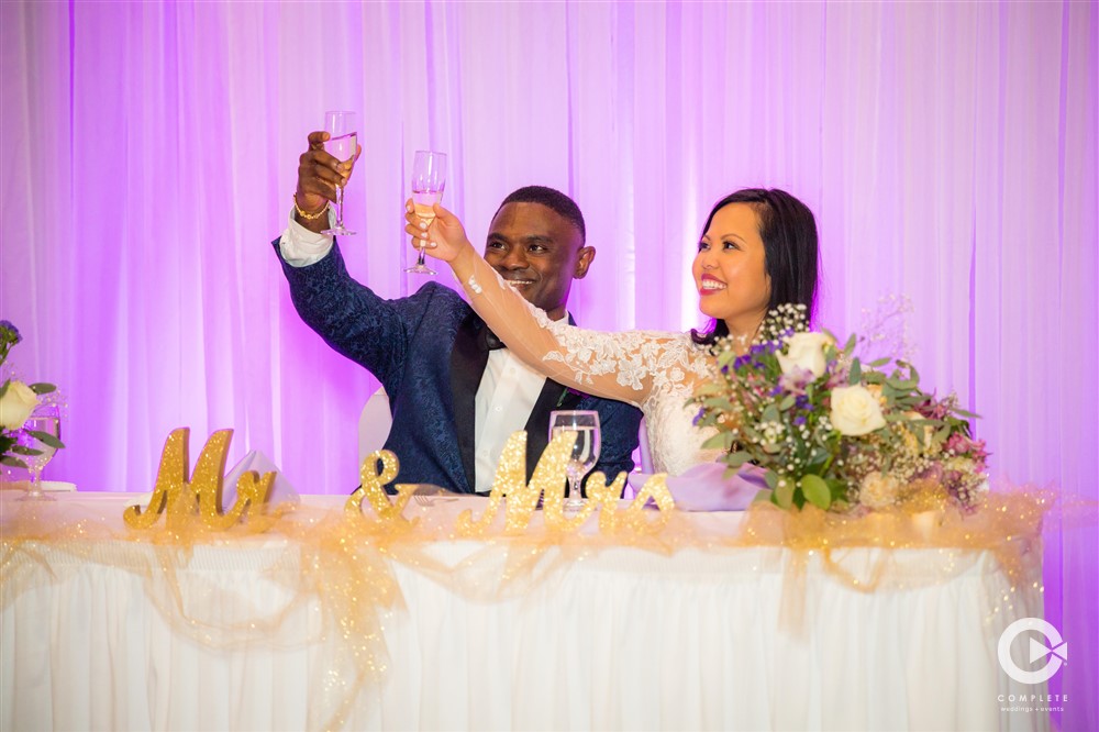 Cheers at couples table wedding in Jacksonville