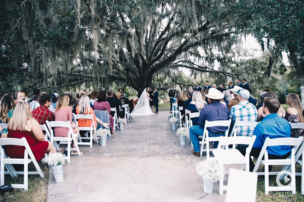 Bride and groom standing at the end of the altar for Laytn's Land-n wedding ceremony outdoors