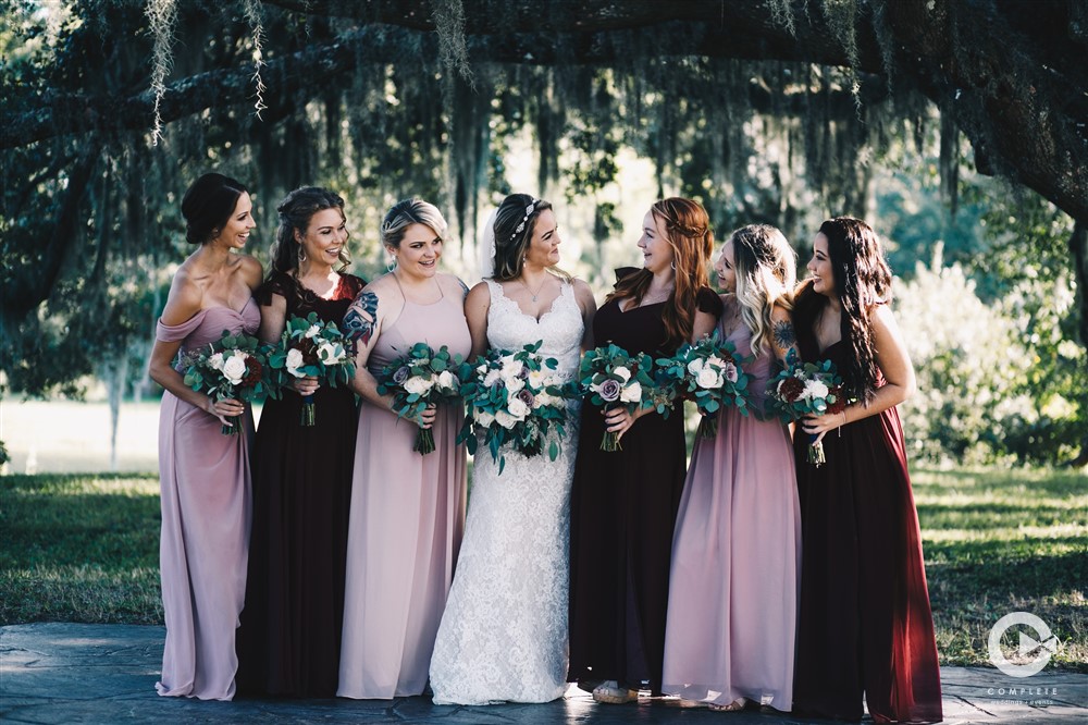 Bride and bridesmaids at Laytn's Land-n wedding venue taking fun photo before wedding reception