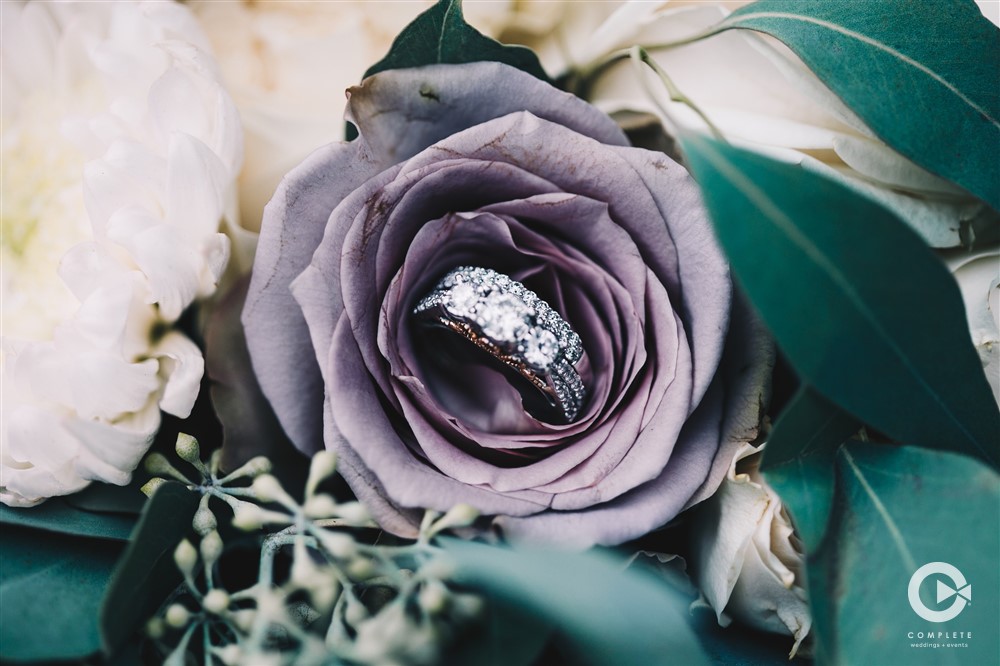 Rings in a gorgeous wedding flower during Yustes Florida wedding in the Fall