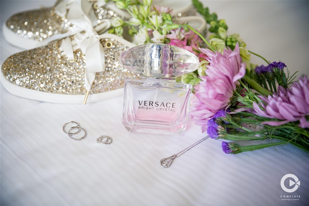 Treaty Park wedding reception detail photo of perfume bottle and wedding flowers