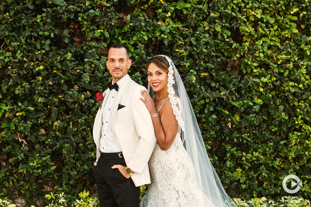 Beautiful bride and groom portrait taken in front of green backdrop during St. Augustine Wedding