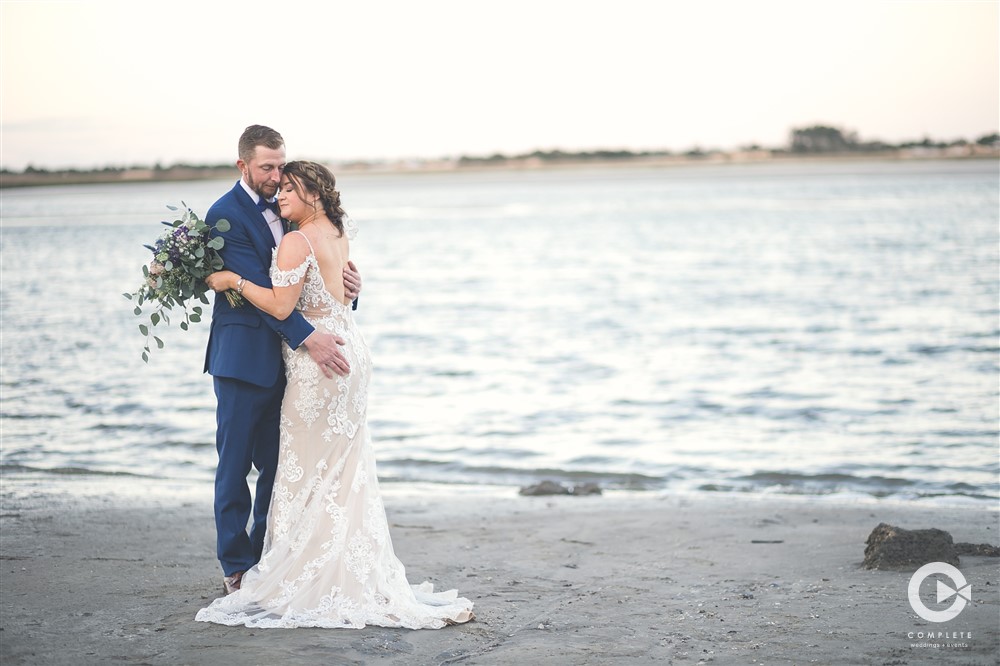 Bride and groom together on the beach during wedding at Ribault Club