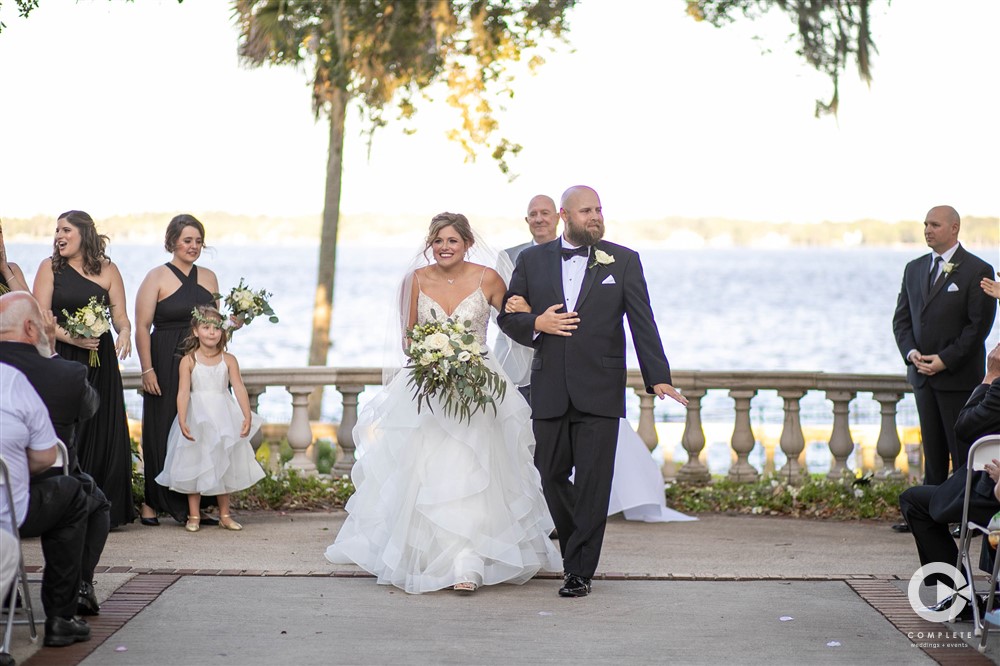 Bride and groom walking down the aisle in Florida | Club Continental Wedding
