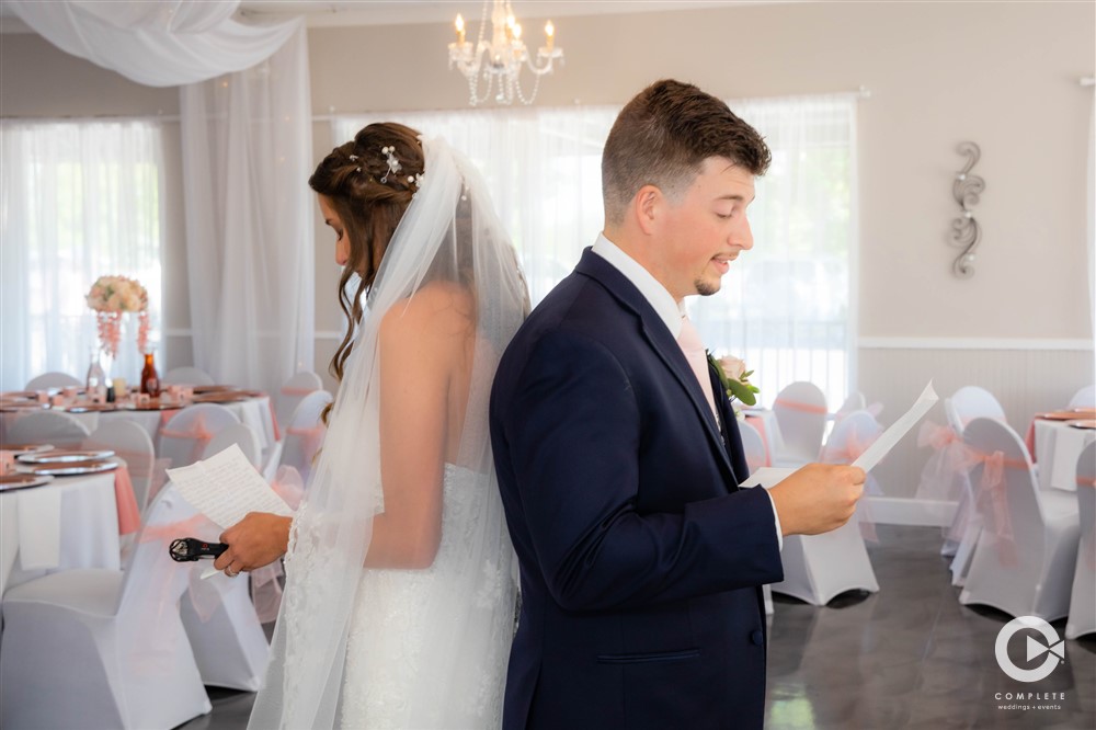 Bride and groom reading their wedding vows before the wedding begins