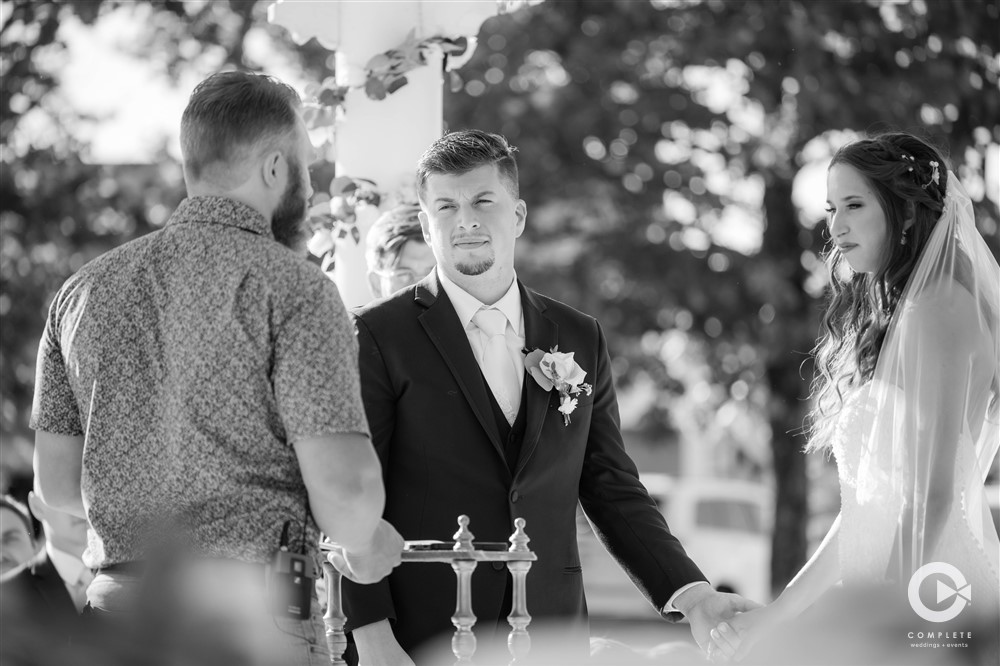 Black and white photo at the altar after bride and groom meet during their ceremony