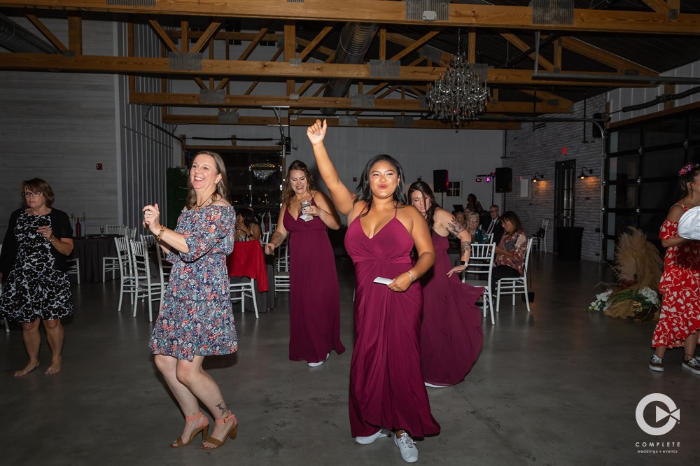 bridesmaids dancing in maroon dresses