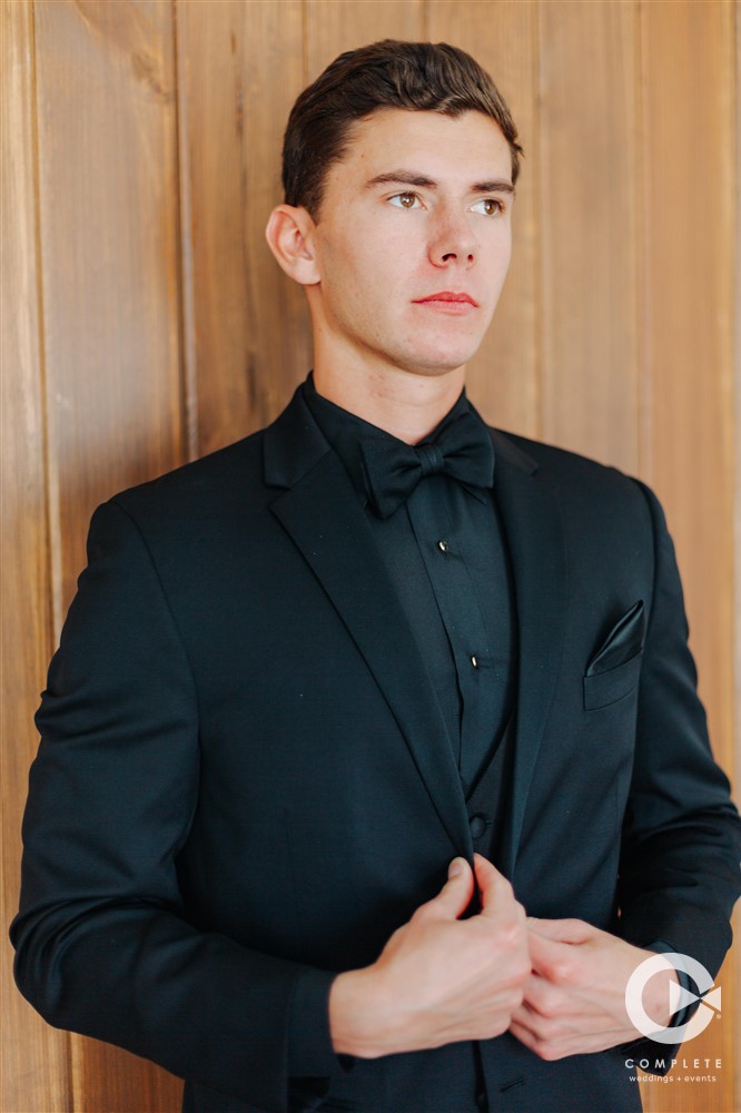 groom in black suit