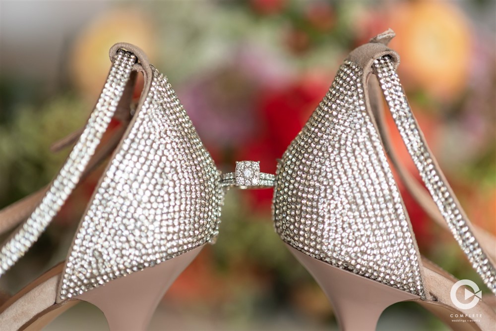 ring in between bride's shoes