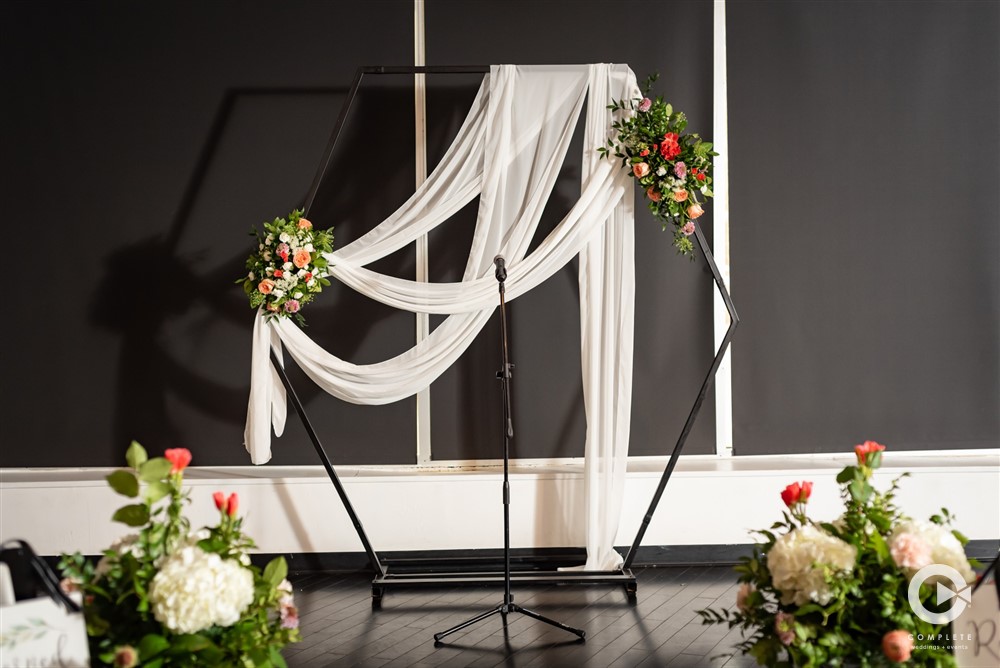 ceremony altar draped in linen and floral decor