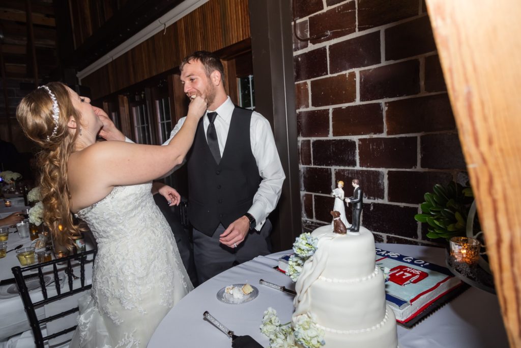 Bride and groom feeding each other cake after cutting their wedding cake near Kansas City.