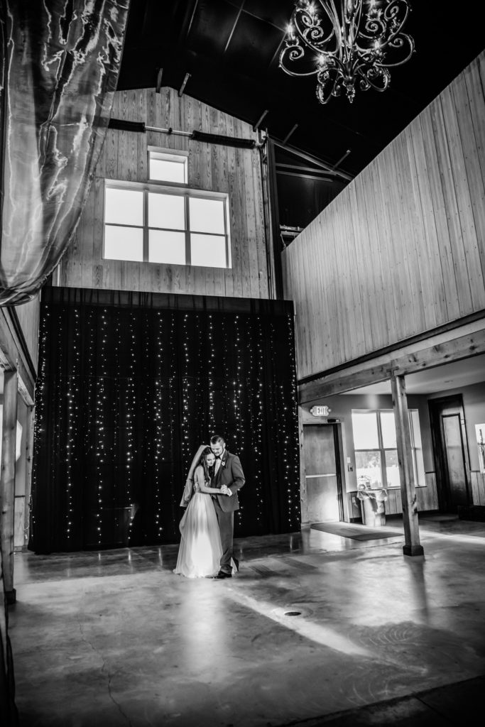 Black and white photograph of wedding couple during their first dance at their wedding near Kansas City.
