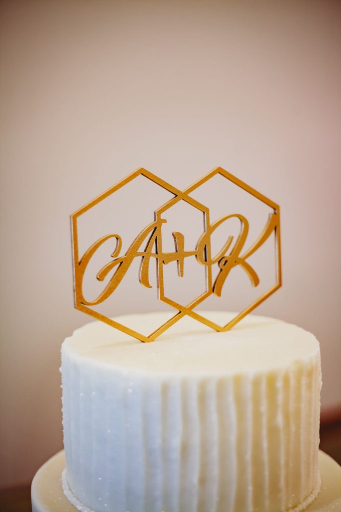 Close up of a gold geometric wedding cake topper