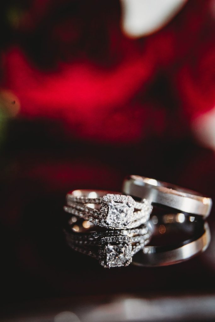 Close up of wedding bands with blurred out red background