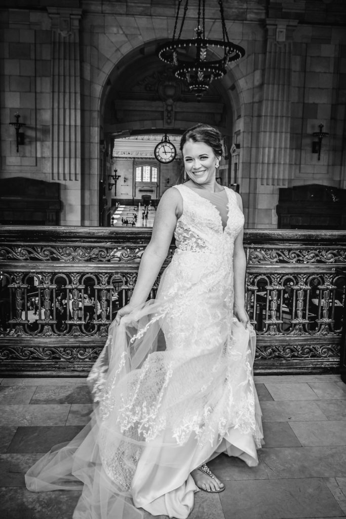 Bride twirling her dress at Union Station with iconic clock in the background