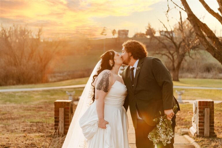 Bride and groom kissing at sunset on the walkway at Belvoir Winery wedding venue photographed by Complete Weddings and Events photographer Serenity