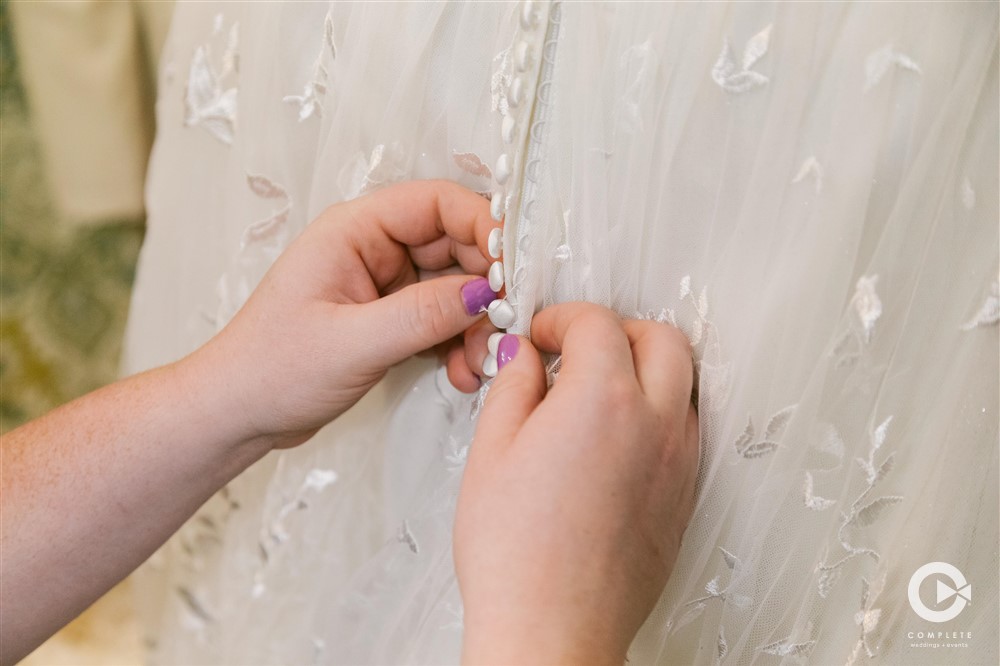 Nebraska High Plains wedding dress being zipped up before ceremony