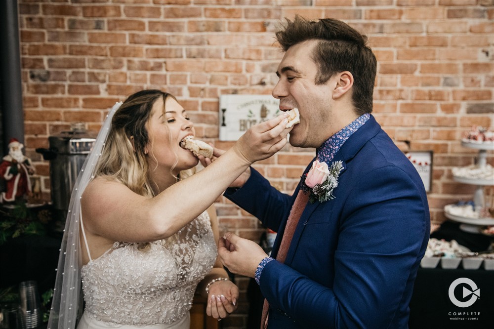 bride and groom eat cake