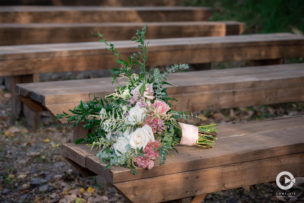 wedding florals on wood seats