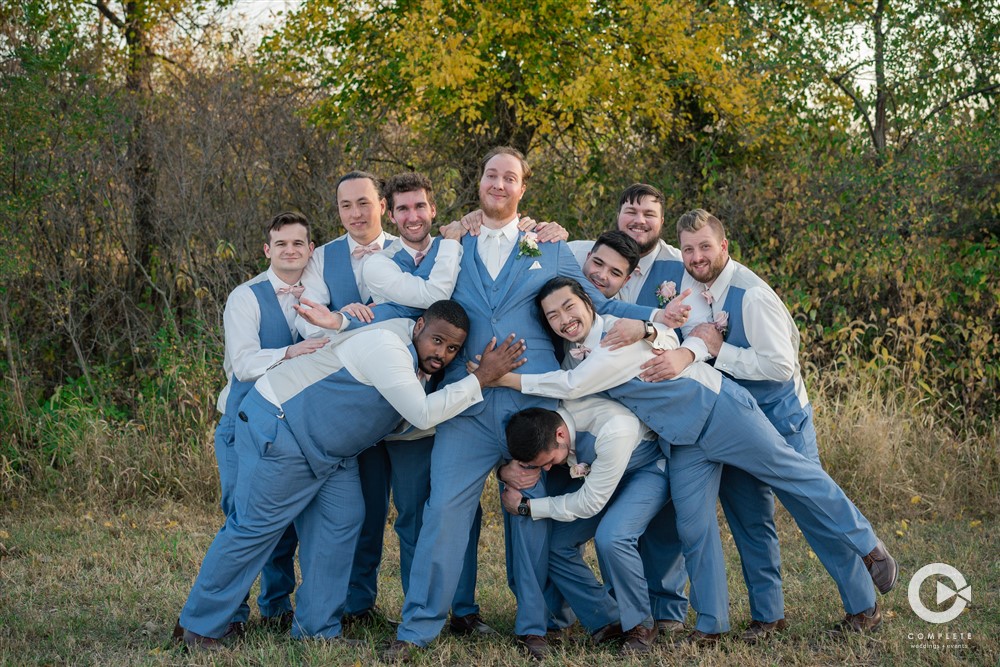 Grooms in tight hugging group