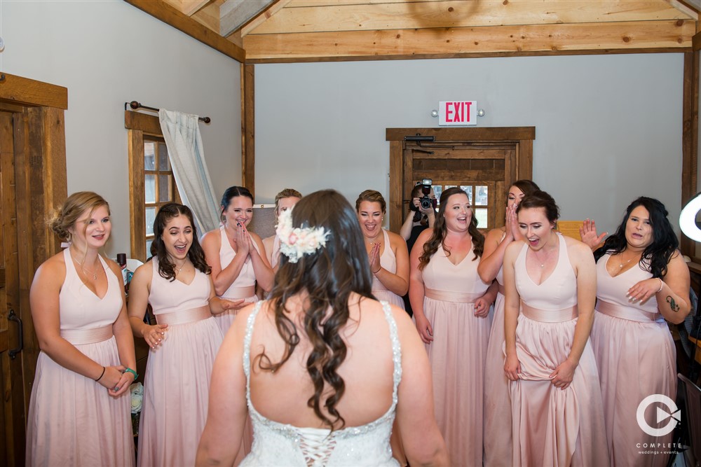 first look with bridesmaid in Roca Berry barn