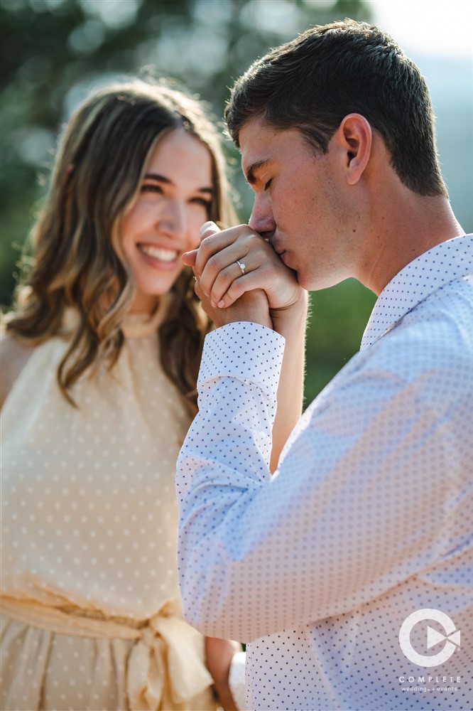 engagement photo of guy kissing hand